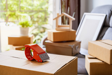 Stack of cardboard boxes in living room at new house on moving day