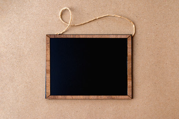Mock-up composition.Advertisement  frames black small board on brown cardboard background copy space.