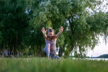 horizontal photo of a young woman doing yoga in nature