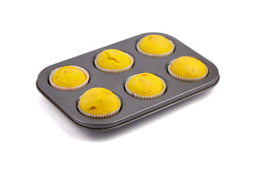 Cupcakes in baking tray isolated on white background. Homemade bakery. Pumpkin muffins