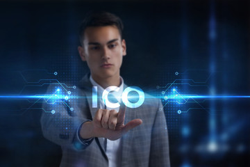 Business, Technology, Internet and network concept. Young businessman working on a virtual screen of the future and sees the inscription: ICO