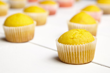Muffins on white table. Cupcakes on wooden background. Homemade bakery
