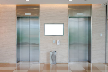 two elevators in the shopping mall and office building, with a white advertising board © Ocean