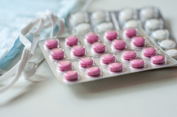 These are Tablets and Disposable medical Masks. Macro Photo. Pharmaceuticals And Medicine.