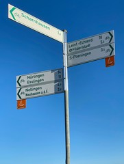 Fototapeta premium Cycle road and bike path near Stuttgart in Germany: Roadsigns are marking directions to various destinations in Stuttgart, Esslingen and Ostfildern for cycling.