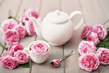 Tea with pink roses on grey wooden table, copy spase. Greeting card for mother's day. Valentine card.Valentine Romantic Breakfast February 14. Women's Day.Happy Birthday! Wedding invitation