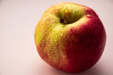 a ripe Apple in drops of water