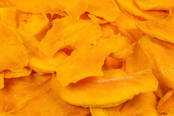 Tasty sugar mango slices background. Top view.