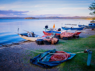 Row of typical fishermen boats docked on Marta beach, a little medieval village on Bolsena lakeshore, Viterbo province, Lazio, Italy
