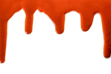 Background of flowing caramel sauce isolated on white.
