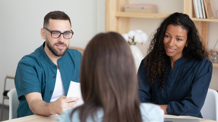 Close up focused african american businesswoman and businessman with resume listening applicant...