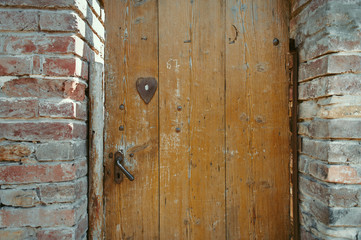 Fototapeta na wymiar Ancient wooden door in old stone castle wall.