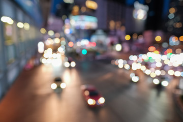 Blurred defocused lights of heavy traffic. Abstract blur image of night light bokeh on street. Blur traffic road with colorful bokeh light. Copy space of transportation and travel concept.