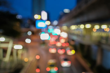 Blurred defocused lights of heavy traffic. Abstract blur image of night light bokeh on street. Blur traffic road with colorful bokeh light. Copy space of transportation and travel concept.