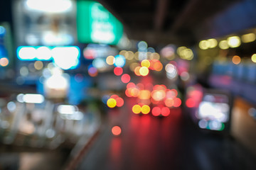Blurred defocused lights of heavy traffic. Abstract blur image of night light bokeh on street. Blur traffic road with colorful bokeh light. Copy space of transportation and travel concept.