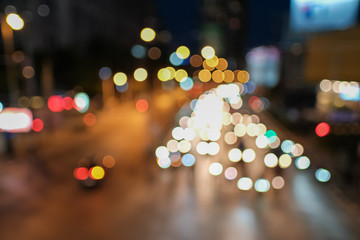 Blurred defocused lights of heavy traffic. Abstract blur image of night light bokeh on street. Blur traffic road with colorful bokeh light. Copy space of transportation and travel concept.
