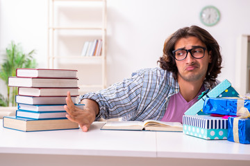 Young male student preparing for exams during Christmas