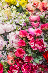 Floral background. Lot of  Decoration artificial flowers in colorful composition