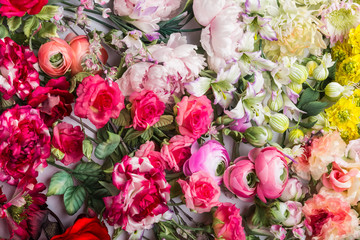 Floral background. Lot of  Decoration artificial flowers in colorful composition