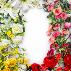 Top view of round frame with decoration artificial flowers, branches, leaves, petals, instruments and paint. isolated on white background. 
