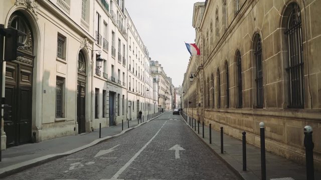 Paris, France / 04 13 2020: Deserted Paris street with french flag during coronavirus / Covid19 lockdown in Paris, France 4K