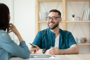 Close up happy bearded man applicant makes good first impression for female hr manager in office. Board smiling male job seeker introduces himself for businesswoman mentor to job at hire meeting.