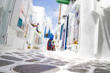 Picturesque scenic narrow streets with traditional whitewashed houses with blue doors windows of...