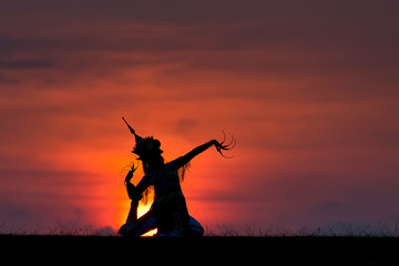 The black silhouette of Manohra actor dancing in the park in the evening. Manohra performance is a folk dance that has a long history in southern Thailand.