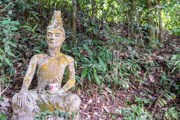 Ancient stone statues in Secret Buddhism Magic Garden, Koh Samui, Thailand. A place for relaxation and meditation. Secret Buddha Garden