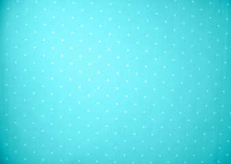 Abstract blue fabric with white polka dot pattern background.