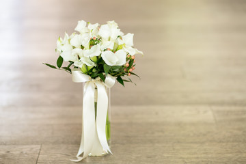 white and green wedding bouquet with long ribbon and copy space