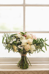 vintage white wedding bouquet set on window ledge