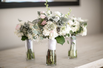multiple simple pink pastel wedding bouquet with nothing on counter 