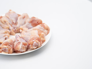 Half plate of chicken wing joint tops with skin and bone on white background. Raw chicken is good ingredient for many menu. High protein and good for weight control.