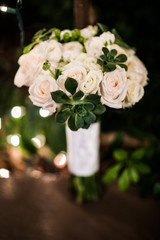 vintage pink wedding bouquet with green succulents at night