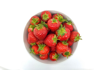 Plump ripe fresh strawberries in a white bowl on a plain white background.