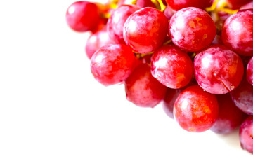 Bunch of red and large grapes on a white background