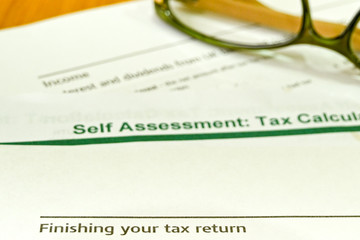 Notes on finishing your tax return on a self assessment tax return calaculation form with a  pair...