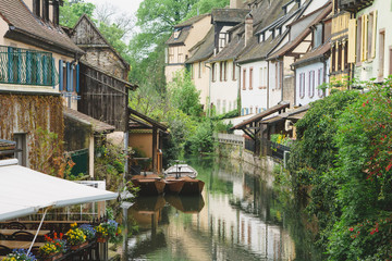 Fototapeta na wymiar Traditional french houses and old boats on the side of river Lauch in Petite Venise, Colmar, France