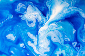 Abstract background of acrylic paint in blue and white. 