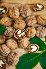 Walnuts and leaves on a  table.