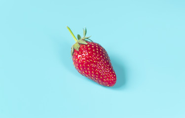 Fresh, red strawberry on light blue background