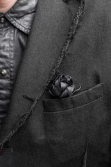 Gothic decoration artificial black rose in a vintage jacket
