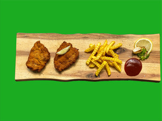 Wiener Schnitzel with french fries on a wooden plate, green background, green screen