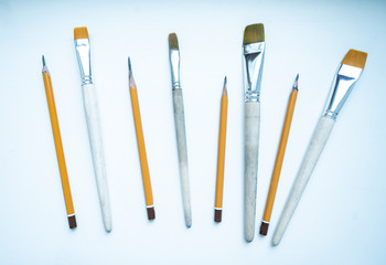 a set of brushes for drawing different sizes and pencils of different hardness slates for creating pictures