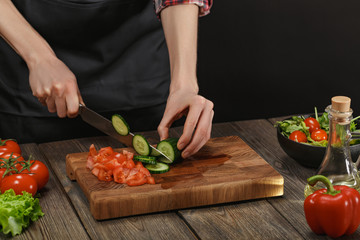 Woman cooking fresh vegetable salad. Female hands. Diet concept for healthy lifestyle with copyspace.