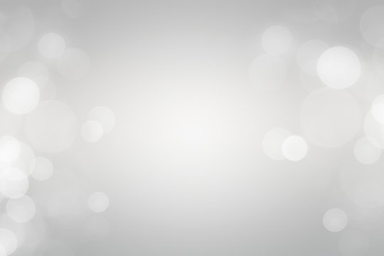 white bokeh defocus glitter blur on gray background. bokeh abstract background.