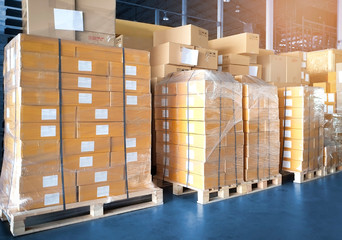 Interior of warehouse storage, stack of cardboard boxes on pallet, package, packaging cartons, manufacturing  shipping logistics and transport