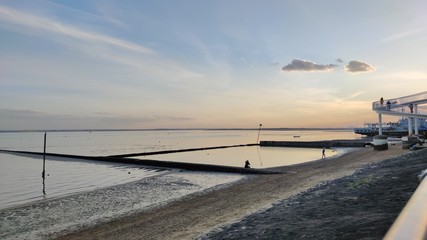 lone female silhouette by the river.