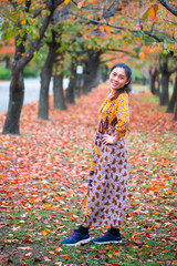 Asian woman in autumn nature background at Osaka park of Japan